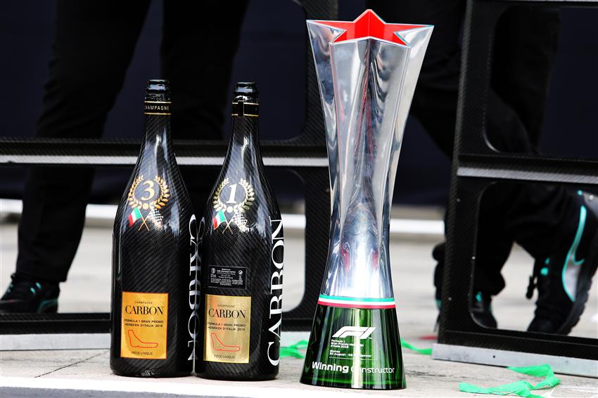 Two champagne bottles and trophies