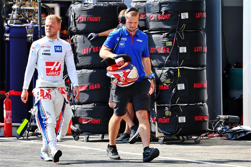 Haas F1 Team walking by Tyres