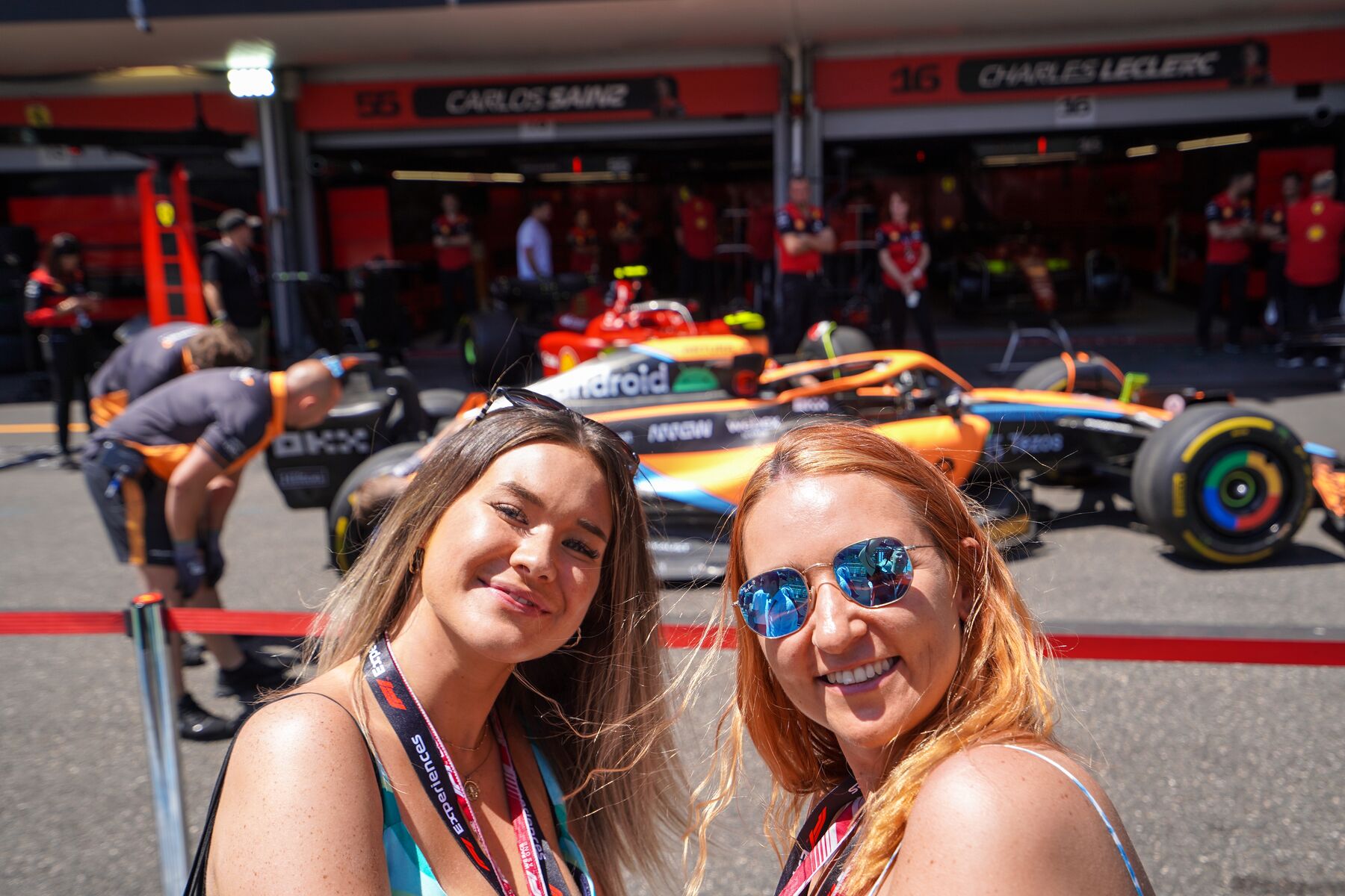Two girls taking selfie outside McLaren garage