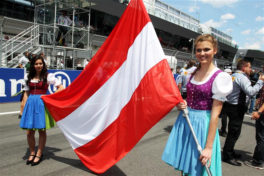 two grid girls holding flags