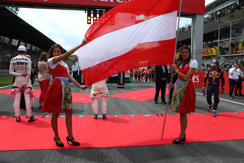 Grid girls holding huge Austrian flag