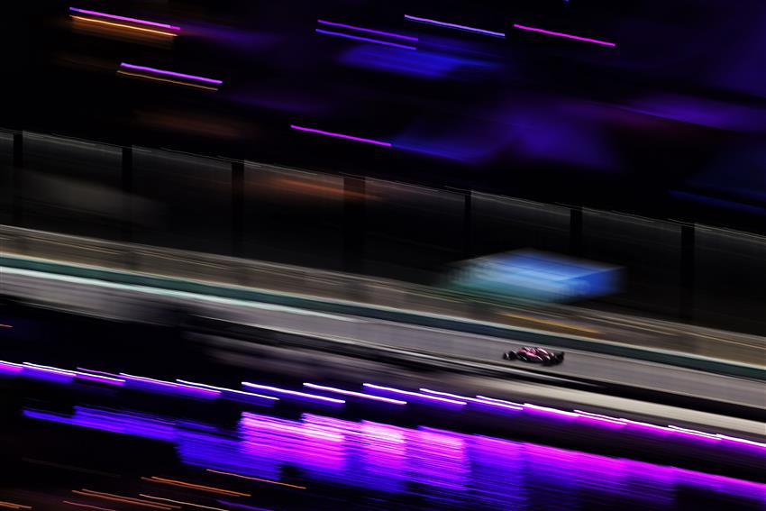 F1 car at night under purple lights