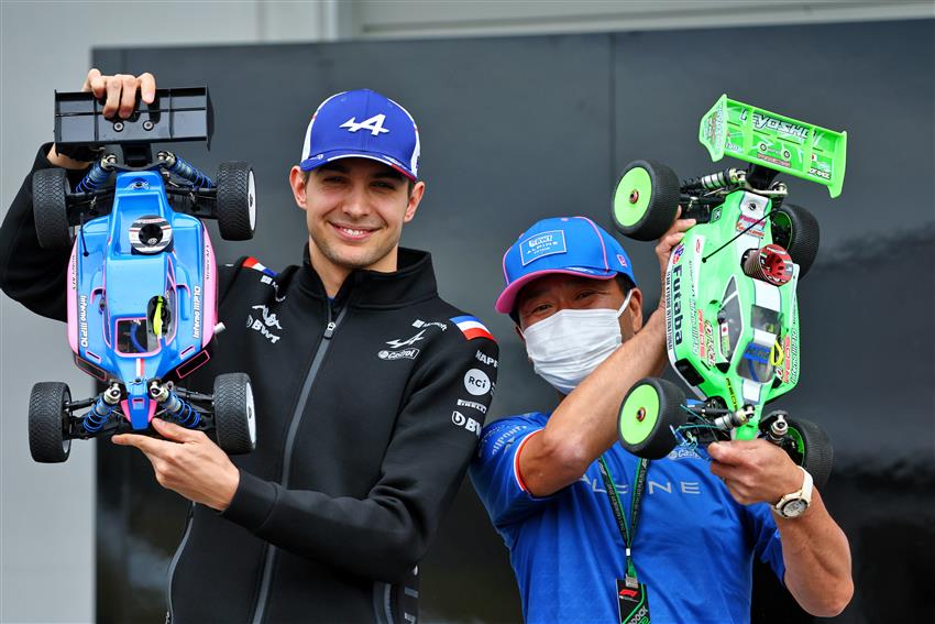 F1 Race fans holding up cars